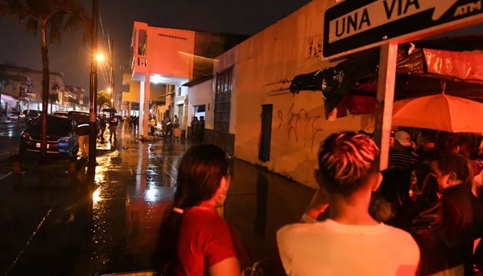 Police officers inspect the scene after a shooting in Guayaquil, Ecuador. — AFP/File