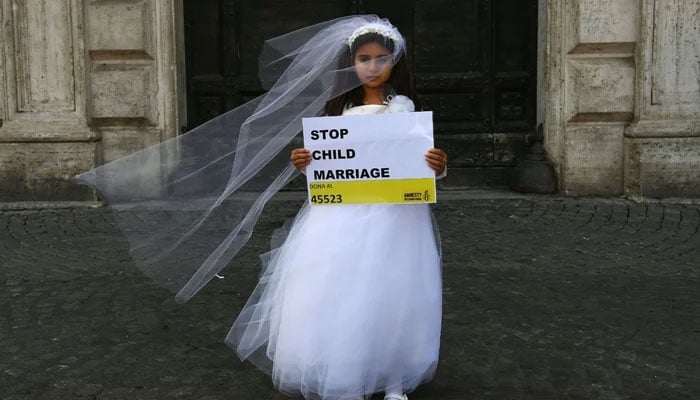 A young actress plays the role of a 10-year-old girl forced to marry a 47-year-old man during an October 2016 happening organized in Rome by Amnesty International to denounce child marriage. — AFP