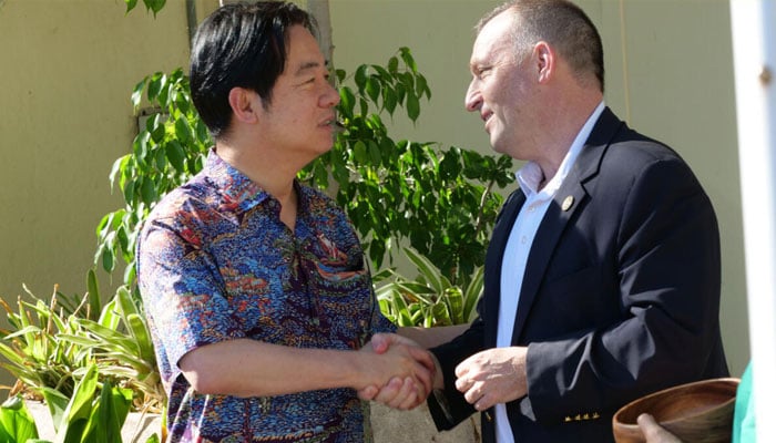 Taiwanese President Lai Ching-te (left) shakes hands with Hawaii Governor Josh Green during his stopover visit to the US island state. —AFP