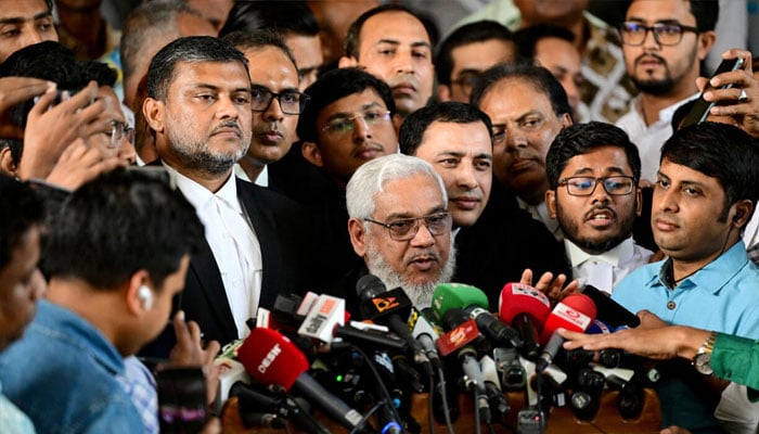 Bangladeshi defence lawyer SM Shahjahan (centre) briefing media. — AFP/File