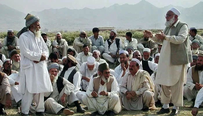 A representational image shows members of a tribe sitting while an elder speaks. — AFP/File