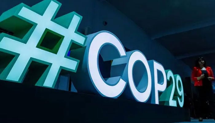 A woman passes by a #COP29 sign during the United Nations climate change conference COP29 in Baku, Azerbaijan on November 11, 2024. — Reuters