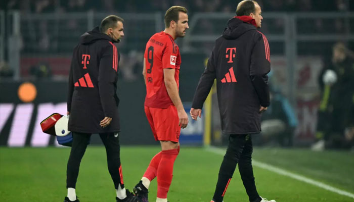 Bayern Munichs English forward Harry Kane (centre) walks out of ground after he suffered a hamstring injury during Saturdays 1-1 Bundesliga draw at Borussia Dortmund. — AFP/File