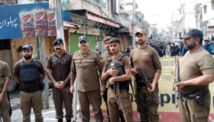 Punjab police personnel standing guard on the road on August 26, 2024. — Facebook@PunjabPolicePakistanOfficial