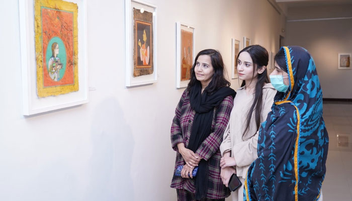 Women look at the painting during the exhibition ‘A Flight of Two Half Birds’ at the PNCA on December 2, 2024. — Facebook@PNCAOfficial