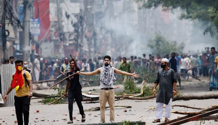 Protesters clash with members of the Border Guard Bangladesh and police outside state-owned Bangladesh Television in Dhaka on July 19, 2024, after violence erupted across the country during anti-job quota protests by students. — Reuters