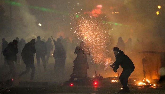 A demonstrator shoots fireworks during a protest against the new governments decision to suspend the European Union accession talks and refuse budgetary grants until 2028, in Tbilisi, Georgia December 2, 2024. — Reuters