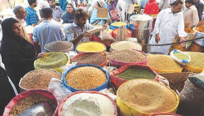 Shoppers are seen buying groceries in Joria Bazaar in Karachi on June 1, 2016. — AFP