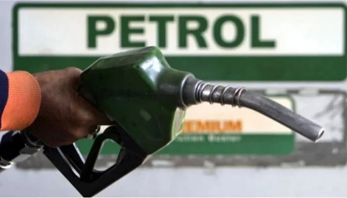 A petrol station worker holds a fuel-filling nozzle at a petrol pump. — Reuters/File