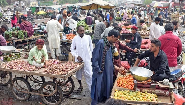 Representational image shows vendors selling vegetables at a market in Lahore on March 26, 2023. — Online