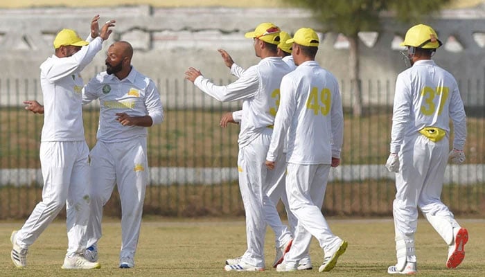 Peshawars Sajid Khan celebrates taking a wicket with teammates in a Quaid-e-Azam Trophy triangular stage fixture against Lahore Whites on December 3, 2024. — PCB