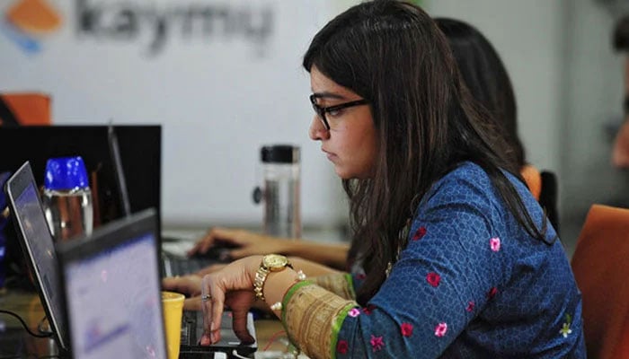 Representational image showing a woman working in an office. — AFP/File