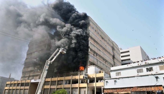 Smoke rises as firefighters struggle to control a fire in a multi-story Rimpa Plaza building at MA Jinnah Road on December 3, 2024. — APP