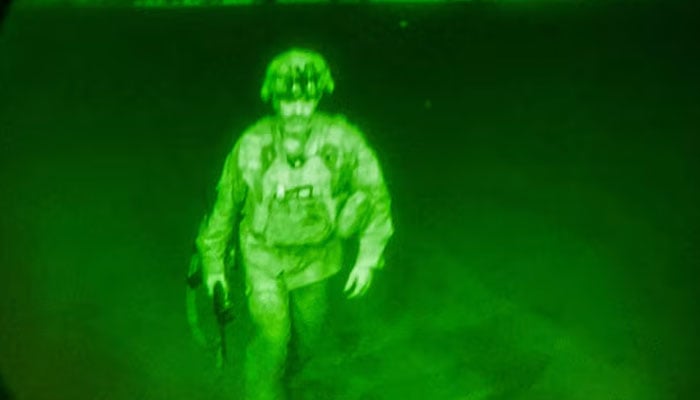 US Army Major General Chris Donahue, commander of the 82nd Airborne Division, steps on board a C-17 transport plane as the last US service member to leave Hamid Karzai International Airport in Kabul, Afghanistan on August 30, 2021 in a photograph taken using night vision optics. — Reuters