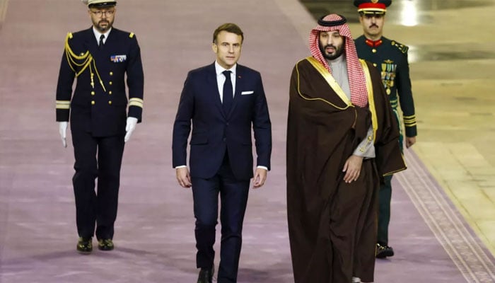 French President Emmanuel Macron (Front left) walks next to Saudi Arabias Crown Prince Mohammed Bin Salman ahead of talks in Riyadh on December 2, 2024. — AFP