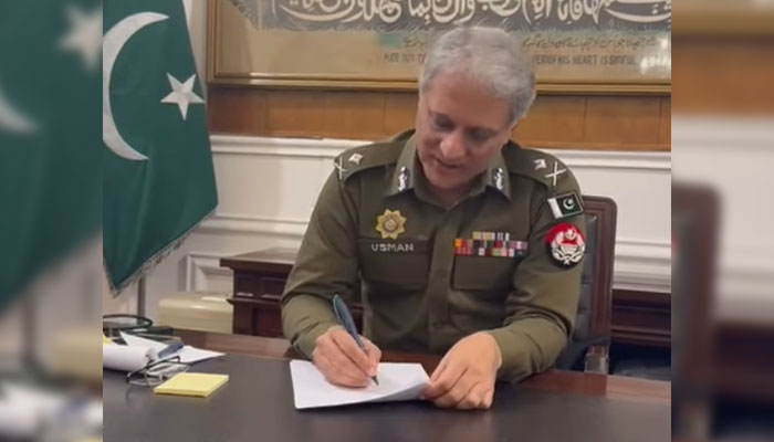 This screengrab, taken on December 4, 2024, shows IG Punjab Dr Usman Anwar signing the notification for the promotion of Traffic Officer. — Facebook@PunjabPolicePakistanOfficial