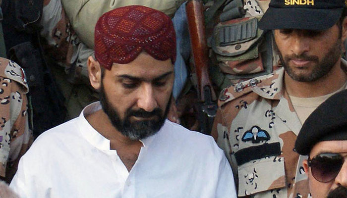 Rangers personnel escort Peoples Aman Committee chief Uzair Baloch from a court in Karachi. — AFP/File