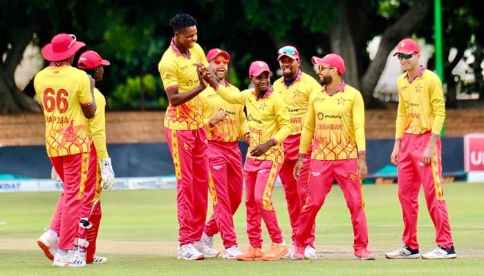 Zimbabwes Blessing Muzarabani celebrates with teammates after taking a wicket during third T20I against Pakistan on December 5, 2024. - X@ZimCricketv