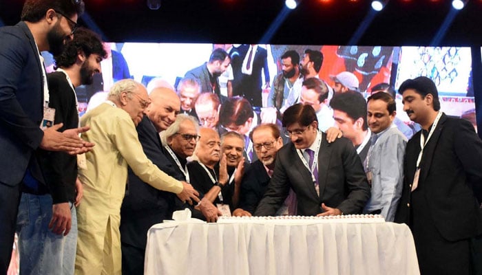 Sindh CM Syed Murad Ali Shah (3rd right) along with President Arts Council of Pakistan Karachi Muhammad Ahmed Shah (4th right) and others cutting a cake to celebrate the 70th anniversary of the Arts Council establishment during the 17th Aalmi Urdu Conference Jashan-e-Karachi 2024 organised by ACP at YMCA Ground in Karachi on December 5, 2024. — PPI