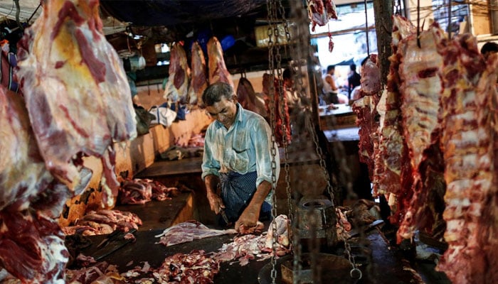 A butcher cuts up portions of beef for sale in an abattoir at a wholesale market in Mumbai, May 11, 2014. — Reuters