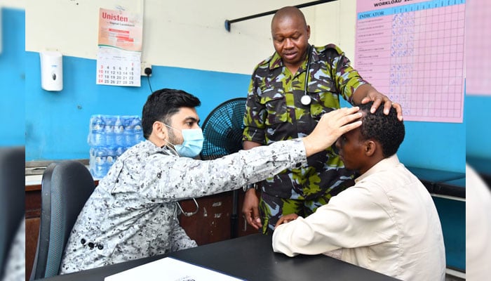 Pakistan Navy medical specialist provides free medical consultations to a patient in Kenya on December 5, 2024. — Facebook@DgprNavy