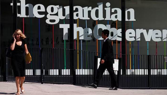 Pedestrians walk past the entrance of the Guardian newspaper building in London August 20, 2013. — Reuters