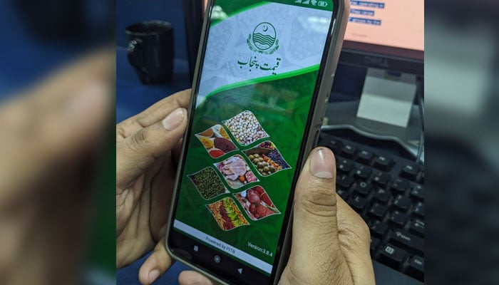 This image taken on December 8, 2024, shows a user opening Qeemat Punjab mobile application on his phone in Karachi. — Thenews.com.pk