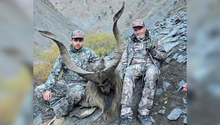 American hunter Ronald Joe Whitton (right) with hunted Markhor seen in this image released on December 8, 2024. — Facebook@Chitral Wildlife Division