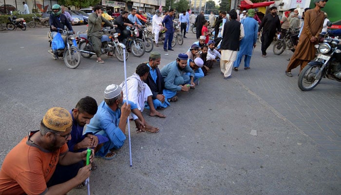 Members of the Sindh Blind Action Committee block a road during a protest for acceptance of their demands, near Karachi Press Club on December 6, 2024. — PPI