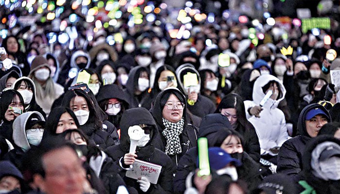 People take part in a protest calling for the ouster of South Korea’s President Yoon Suk Yeol outside the National Assembly in Seoul on Sunday. — AFP/File