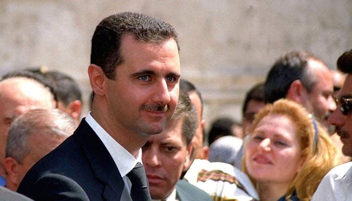 Bashar al-Assad, smiles at the crowd gathered in front of a polling station in Damascus on July 10, 2000.— AFP