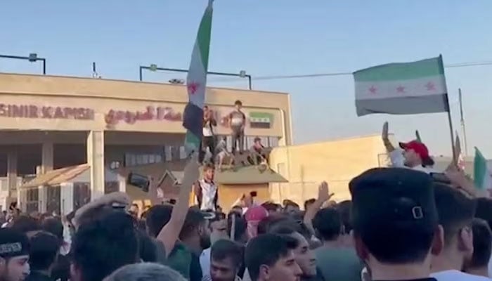 Protesters gather with the Syrian flag in Bab al-Salameh in Aleppo countryside, Syria, July 1, 2024. — Reuters