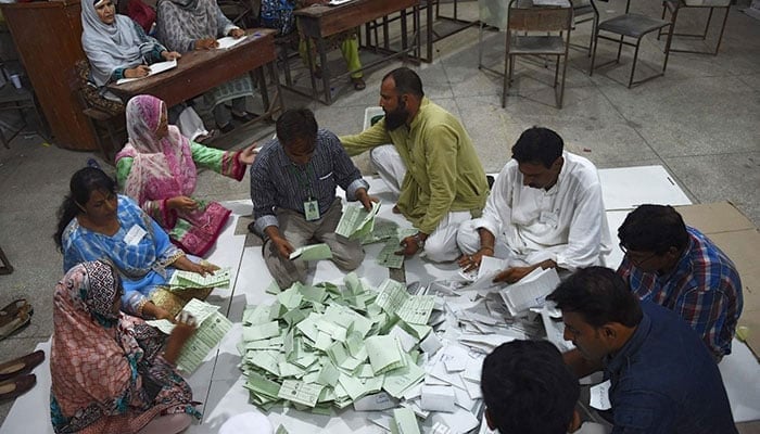 Election commission’s staff count votes in Karachi. — AFP/File