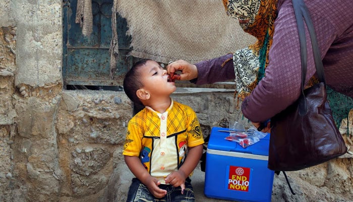 A boy receives polio vaccine drops, during an anti-polio campaign, in a low-income neighbourhood in Karachi. — Reuters/File