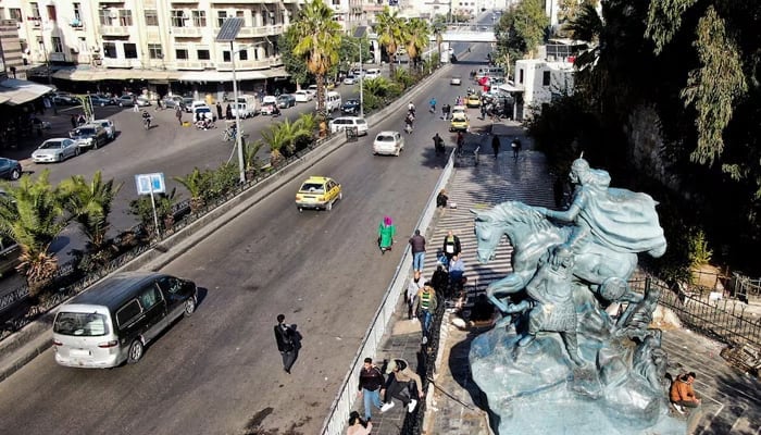 A drone view shows people walking near a statue in Damascus, after Syrian rebels ousted President Bashar al-Assad, Syria December 10, 2024. — Reuters