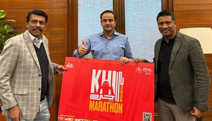 Karachi Mayor Barrister Murtaza Wahab (centre) poses with the Karachi Marathon 2025 banner in Karachi on December 13, 2024. — Facebook@barristermurtazawahabofficial