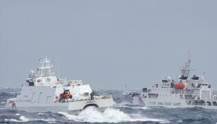 A Taiwanese coast guard ship (left) sails near a Chinese vessel a few nautical miles from Taiwans northeastern coast. — AFP/File