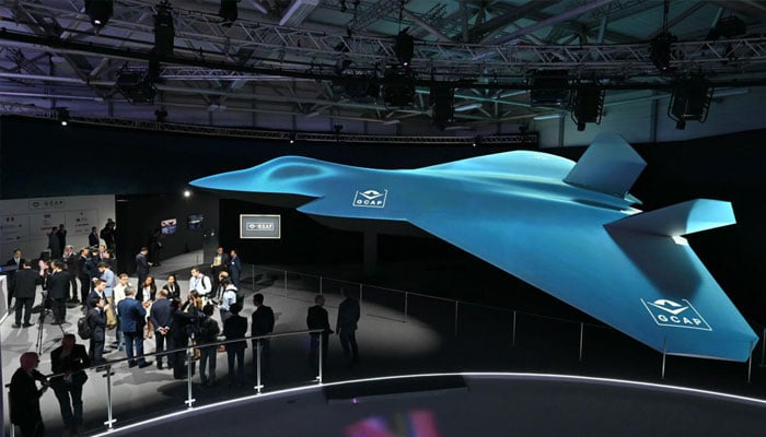 Delegates look at the Global Combat Air Programme (GCAP) 6th generation fighter jet concept design at the Farnborough International Airshow 2024.— AFP