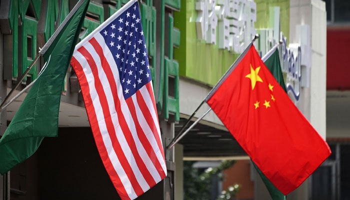 US and Chinese flags displayed outside a hotel in Beijing, China. — AFP/File