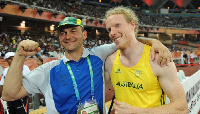 Australia’s Steve Hooker (right) salutes the crowd with coach Alex Parnov after the men’s pole vault final at Commonwealth Games. — AFP/File