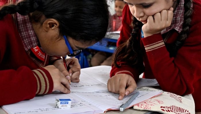 Children attend a class at a school. — AFP/File