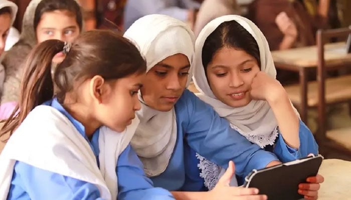 In this representational image, students use a device in School. — APP/File