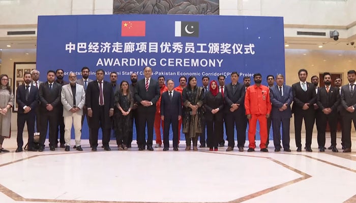 Chinese Ambassador Jiang Zaidong (centre) poses for a photo with staff of CPEC projects during a ceremony organised by the Embassy of China in Pakistan on December 15, 2024. — Screengrab via Facebook@china.pakistan.friends