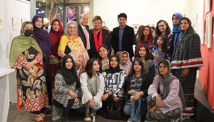 Participants pose for a group photo during an art exhibition titled ‘Miniatures of Karachiites’ at Port Grand’s Art Lane gallery on December 15, 2024. — Facebook@rumana.husain.7