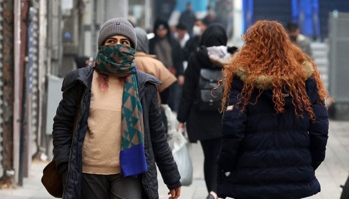 Iranian women walk in a street in the capital Tehran on December 12, 2024. — AFP