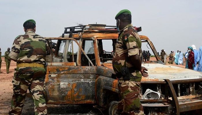 Nigerian army officers inspect a car belonging to the French aid group ACTED, after an attack by extremists, in the Kouré Reserve, about 60km from Niamey, on August 21, 2020. —AFP