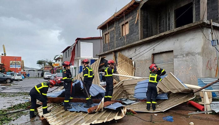 Members of the French Civil Security clean debris after Cyclone Chido hit Mayotte on December 15, 2024.— AFP