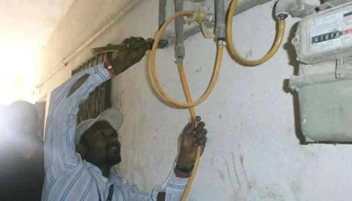 This representational image shows a worker repairing a gas meter. — APP/File