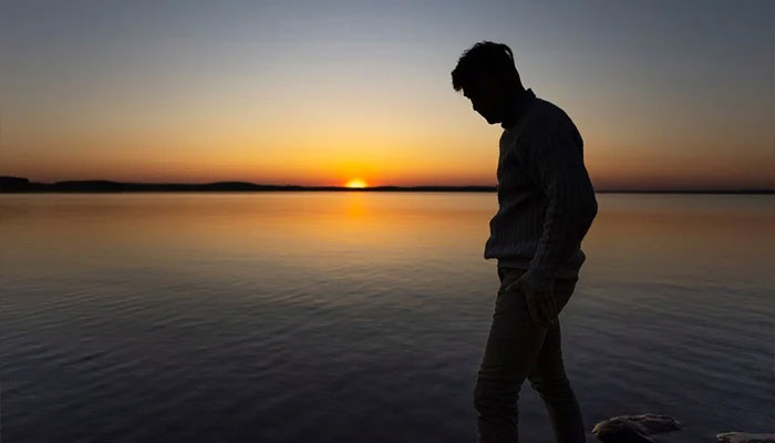 Representational photo shows a person walking near lake during sunset. — Freepik/File