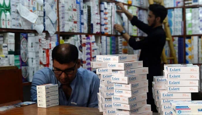 Representational image shows pharmacists arranging medicines at a pharmacy shop. — AFP/File